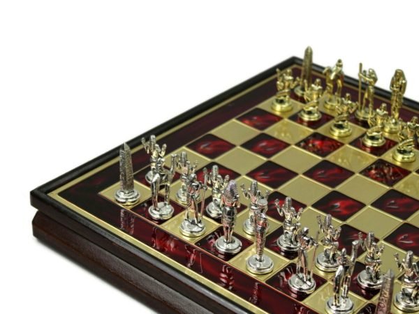 red metal chess set wooden frame and metal chess pieces