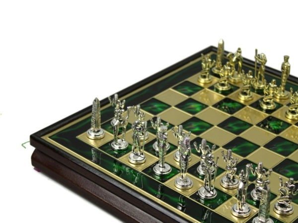 green metal framed chess board and chess pieces
